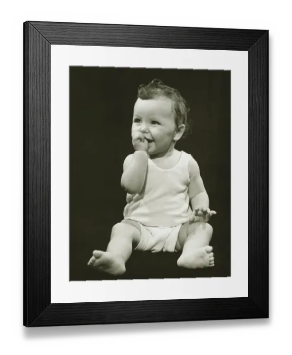 Framed Print : Baby boy (12-18 months) sucking thumb, (B&W), close-up Framed Print : Baby boy (12-18 months) sucking thumb, (B&W), close-up