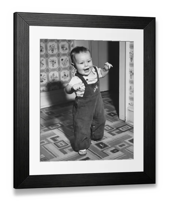 Framed Print : Boy (18-24 months) learning to walk, (B&W)