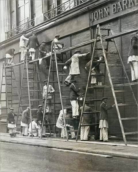 Group of painters on ladders