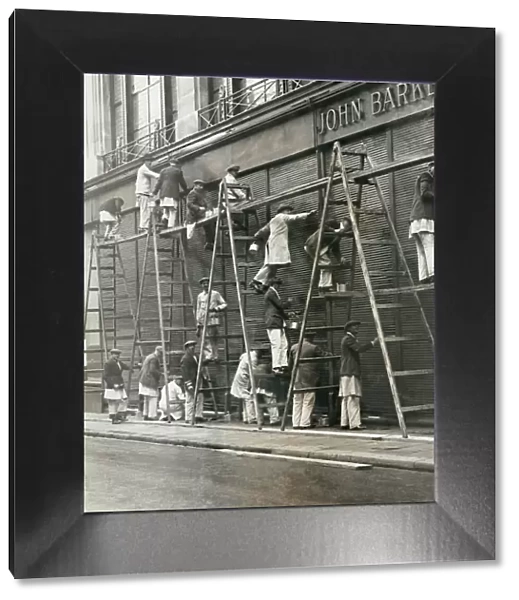 Group of painters on ladders