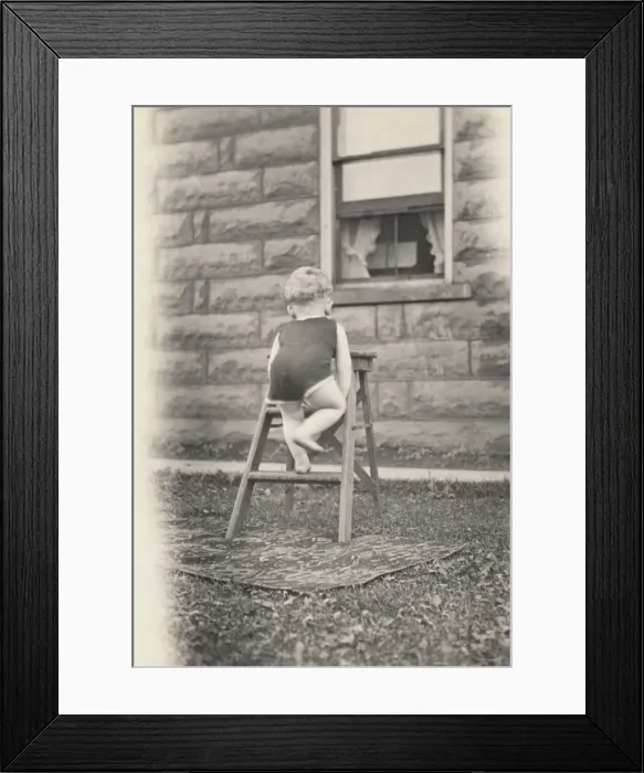 Framed Print : Rear View of a Toddler Climbing a Stepladder in a Garden Framed Print : Rear View of a Toddler Climbing a Stepladder in a Garden
