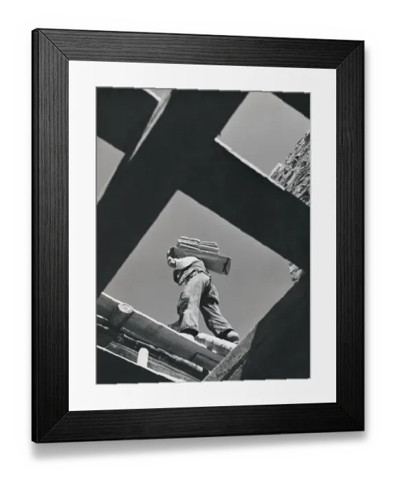 Framed Print : Worker carrying materials, seen from below Framed Print : Worker carrying materials, seen from below