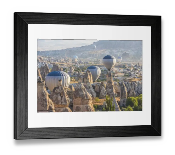 Framed Print : Hot air balloon flying over rock landscape at Cappadocia Turkey Framed Print : Hot air balloon flying over rock landscape at Cappadocia Turkey