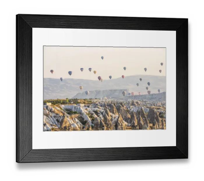 Framed Print : Hot air balloon flying over rock landscape at Cappadocia Turkey Framed Print : Hot air balloon flying over rock landscape at Cappadocia Turkey