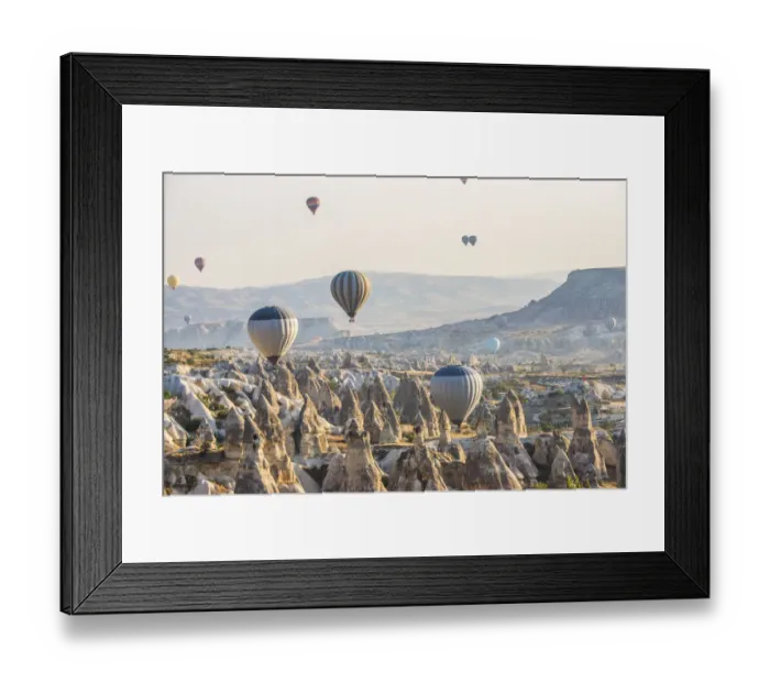 Framed Print : Hot air balloon flying over rock landscape at Cappadocia Turkey Framed Print : Hot air balloon flying over rock landscape at Cappadocia Turkey