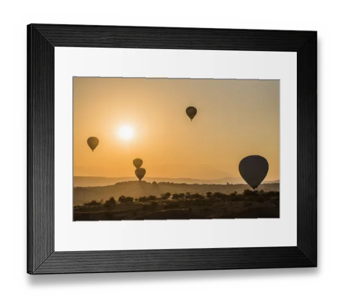 Framed Print : Hot air balloon flying over rock landscape at Cappadocia Turkey