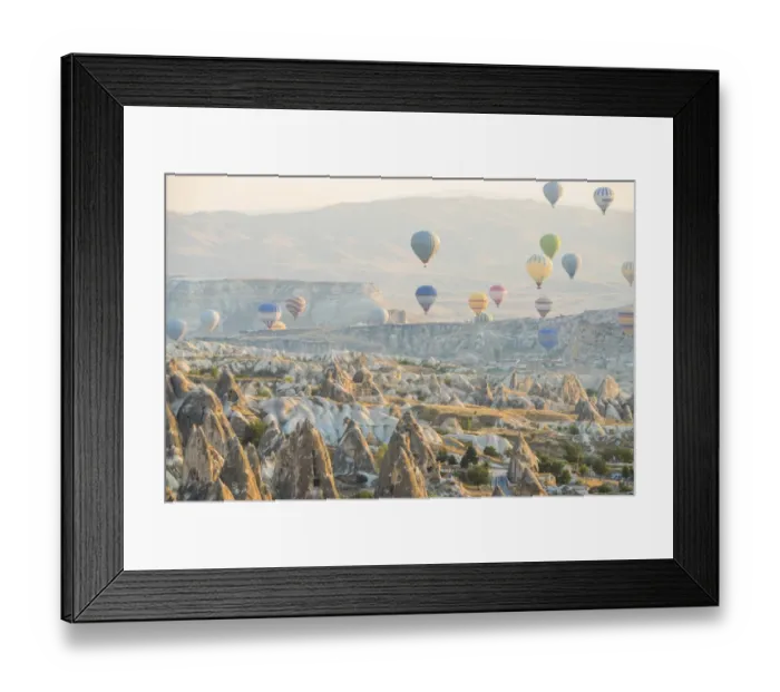 Framed Print : Hot air balloon flying over rock landscape at Cappadocia Turkey Framed Print : Hot air balloon flying over rock landscape at Cappadocia Turkey