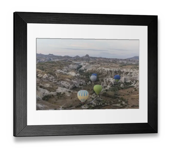 Framed Print : Hot air balloon flying over rock landscape at Cappadocia Turkey Framed Print : Hot air balloon flying over rock landscape at Cappadocia Turkey