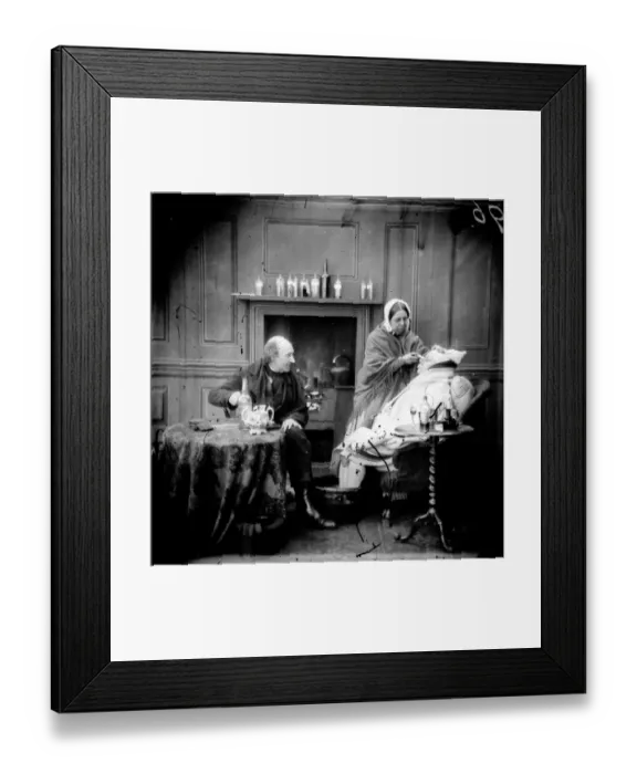 Framed Print : Home Care. circa 1865: A woman sitting with her feet in a bowl of water Framed Print : Home Care. circa 1865: A woman sitting with her feet in a bowl of water