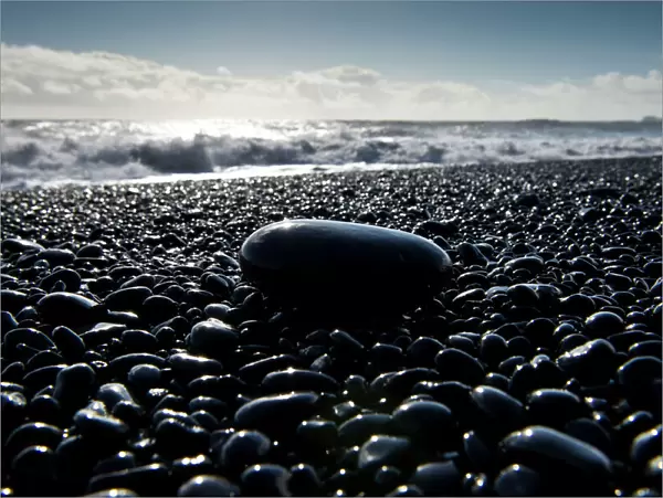 Surf, black pebbles on the lava beach of Reynisfjara near Vik i Myrdal, South Coast, Iceland