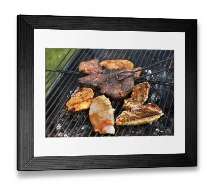 Framed Print : Heavily roasted meat on a charcoal grill