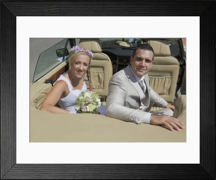 Framed Print : Bride and groom posing in the back seat of an open car, convertible Framed Print : Bride and groom posing in the back seat of an open car, convertible