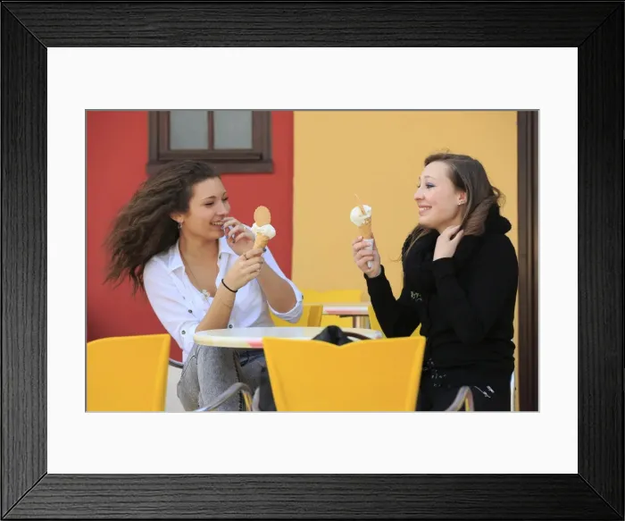 Framed Print : Two girlfriends, teenagers, eating ice cream from cone on the terrace an ice cream parlour, Menton, Alpes-Maritimes, Provence-Alpes-Cote dAzur, France Framed Print : Two girlfriends, teenagers, eating ice cream from cone on the terrace an ice cream parlour, Menton, Alpes-Maritimes, Provence-Alpes-Cote dAzur, France