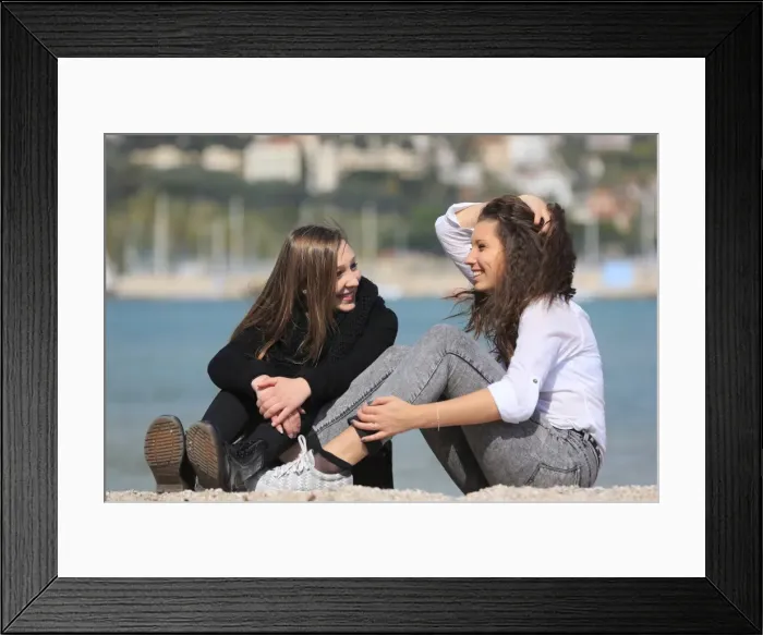 Framed Print : Two girlfriends, teenagers, sitting on the beach, Menton, Alpes-Maritimes, Provence Alpes, France Framed Print : Two girlfriends, teenagers, sitting on the beach, Menton, Alpes-Maritimes, Provence Alpes, France