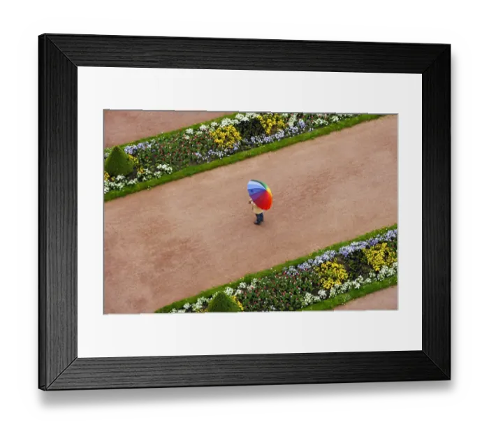 Framed Print : Person with umbrella in rainbow colors on a red gravel path between flower beds in the castle gardens, Fuldaer Stadtschloss City Palace, Fulda, Hesse, Germany Framed Print : Person with umbrella in rainbow colors on a red gravel path between flower beds in the castle gardens, Fuldaer Stadtschloss City Palace, Fulda, Hesse, Germany