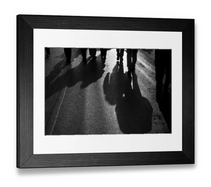 Framed Print : Backlit persons casting shadows on the asphalt Framed Print : Backlit persons casting shadows on the asphalt