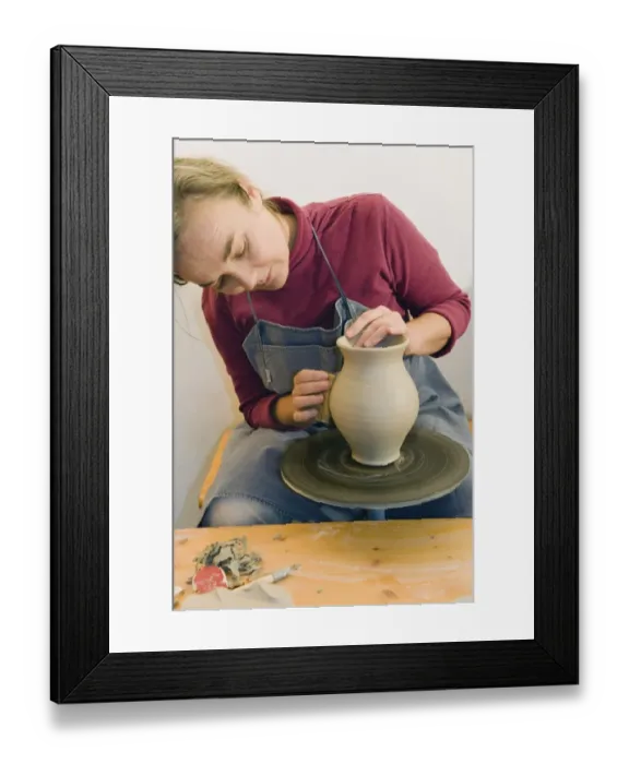 Framed Print : Ceramic artist working in her workshop with a potters wheel, polishing the surface of a pitcher, Geisenhausen, Bavaria, Germany, Europe Framed Print : Ceramic artist working in her workshop with a potters wheel, polishing the surface of a pitcher, Geisenhausen, Bavaria, Germany, Europe