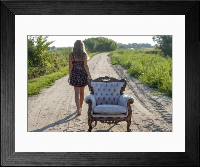 Framed Print : Girl, 14 years, walking along a track, an old armchair in front Framed Print : Girl, 14 years, walking along a track, an old armchair in front