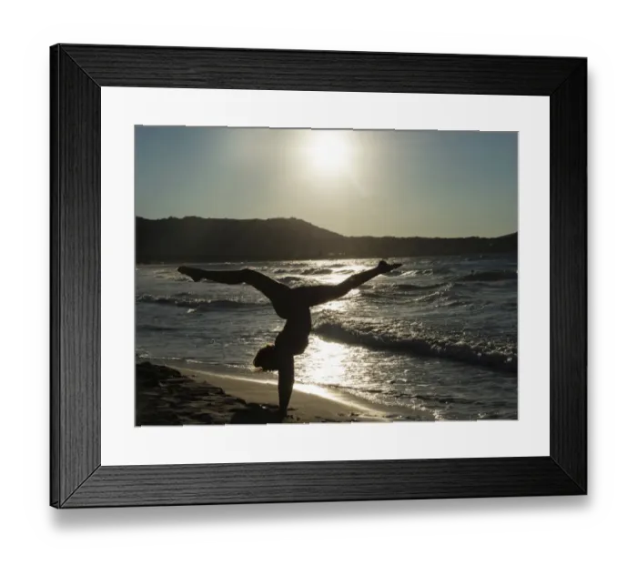 Framed Print : Young woman doing gymnastics on the beach, backlight, Corsica, France Framed Print : Young woman doing gymnastics on the beach, backlight, Corsica, France