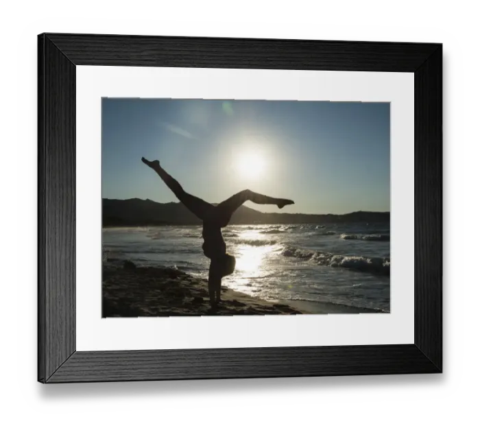 Framed Print : Young woman doing gymnastics on the beach, backlight, Corsica, France Framed Print : Young woman doing gymnastics on the beach, backlight, Corsica, France