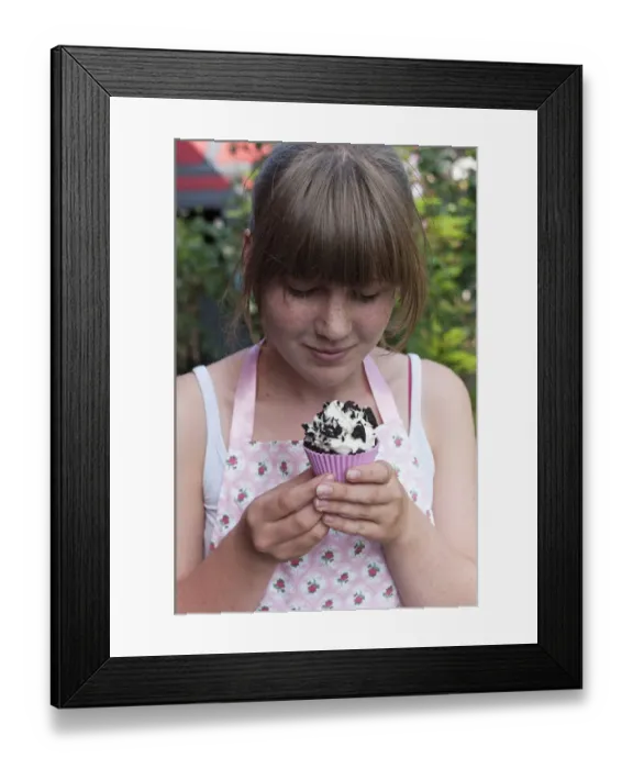 Framed Print : Girl looking at a homemade Oreo brownie cupcake Framed Print : Girl looking at a homemade Oreo brownie cupcake