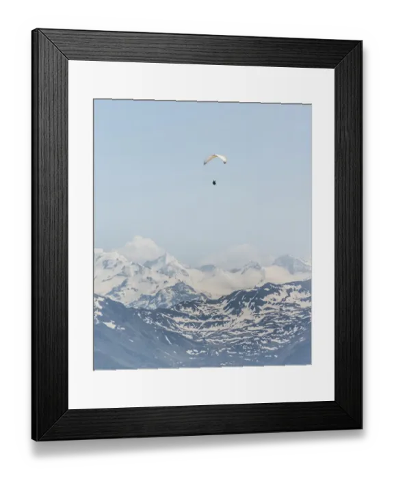 Framed Print : Paraglider against a blue sky, snow-capped peaks of the Alps at the back Framed Print : Paraglider against a blue sky, snow-capped peaks of the Alps at the back
