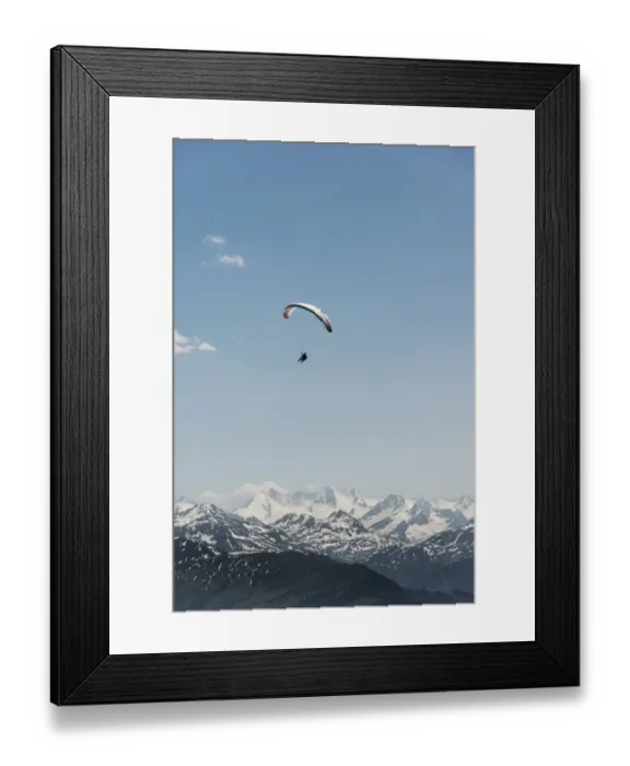 Framed Print : Paraglider against a blue sky, snow-capped peaks of the Alps at the back Framed Print : Paraglider against a blue sky, snow-capped peaks of the Alps at the back