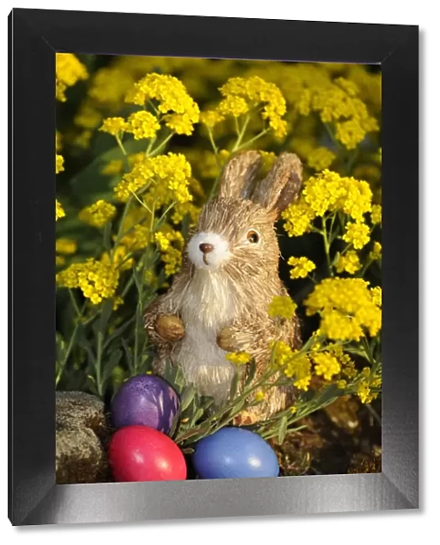 Easter bunny figure with brightly coloured Easter eggs
