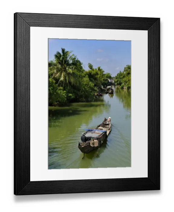 Framed Print : Small wooden motorboat passing through a water channel surrounded by tropical vegetation, Hue, Vietnam, Asia Framed Print : Small wooden motorboat passing through a water channel surrounded by tropical vegetation, Hue, Vietnam, Asia
