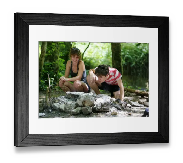 Framed Print : Woman and man having a barbecue in a clearing Framed Print : Woman and man having a barbecue in a clearing