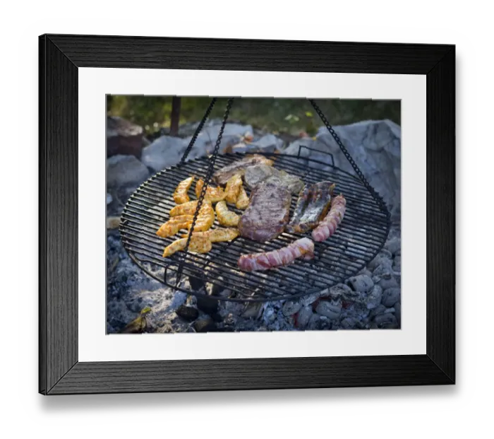Framed Print : Meat and sausages being cooked on a grill hanging on chains Framed Print : Meat and sausages being cooked on a grill hanging on chains