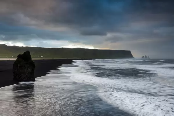 Reynisdrangar rock formation, dramatic clouds, black sand beach, near Vik i Myrdal, South Coast, Suourland, Iceland