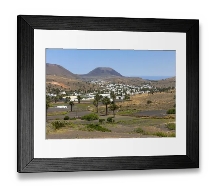 Framed Print : The mountain village of Haria, with its white houses, the volcano Monte Corona at the back, Maguez, Lanzarote, Canary Islands, Spain