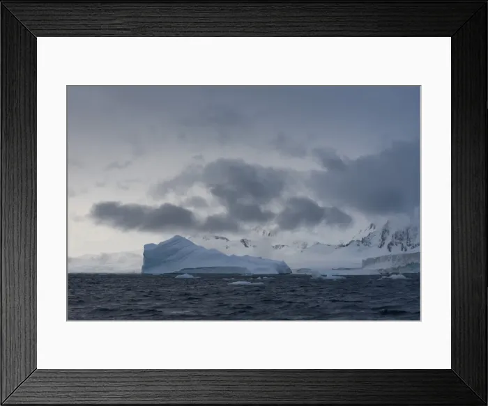 Framed Print : Iceberg in a fjord with mountain scenery and a cloudy sky, Gerlache Strait, Antarctic Peninsula, Antarctica Framed Print : Iceberg in a fjord with mountain scenery and a cloudy sky, Gerlache Strait, Antarctic Peninsula, Antarctica