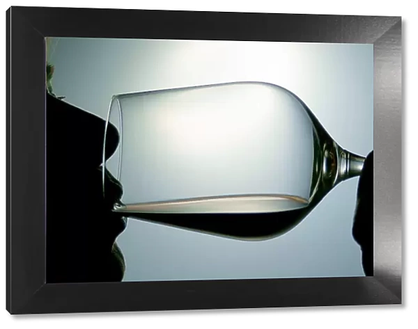Woman drinking red wine, silhouette