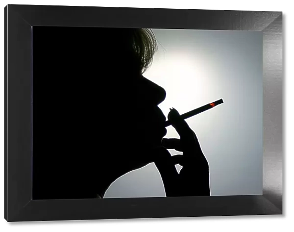 Woman smoking a cigarette, silhouette