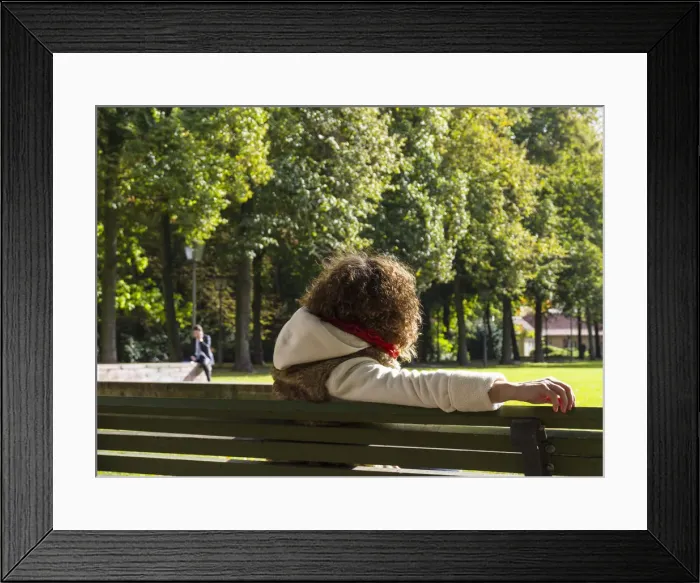 Framed Print : Young woman sitting on a bench watching a man speaking on the phone, Berlin, Germany, Europe Framed Print : Young woman sitting on a bench watching a man speaking on the phone, Berlin, Germany, Europe