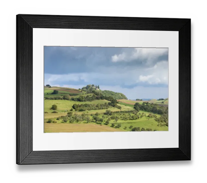 Framed Print : Agricultural land in the hills of the Hegau region with fields, orchards and pastures, Maegdeberg hill with castle ruins at back, Baden-Wuerttemberg, Germany, Europe