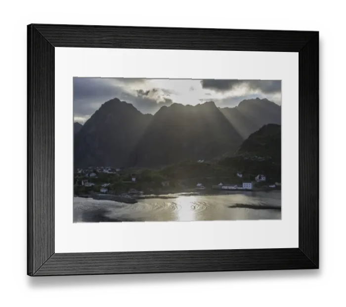 Framed Print : Sun rays breaking through the clouds over the mountains of the municipality of Moskenes, Lofoten, Nordland, Norway Framed Print : Sun rays breaking through the clouds over the mountains of the municipality of Moskenes, Lofoten, Nordland, Norway