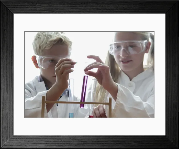Framed Print : Girl and boy playfully doing chemistry experiments