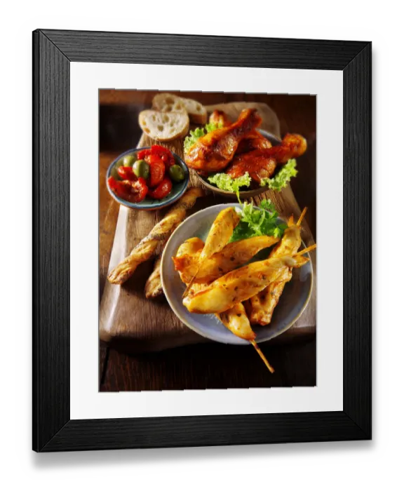Framed Print : Party buffet with chicken satay and grilled chicken legs Framed Print : Party buffet with chicken satay and grilled chicken legs
