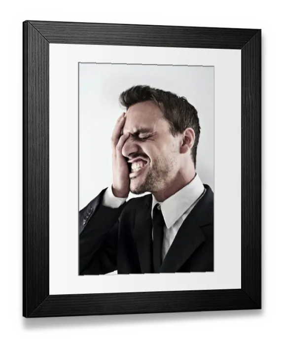 Framed Print : Desperate young man wearing a suit covering his face with his hand, screaming Framed Print : Desperate young man wearing a suit covering his face with his hand, screaming
