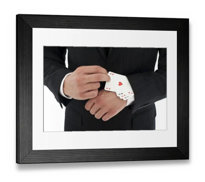 Framed Print : Man wearing a suit pulling several aces out of his sleeve