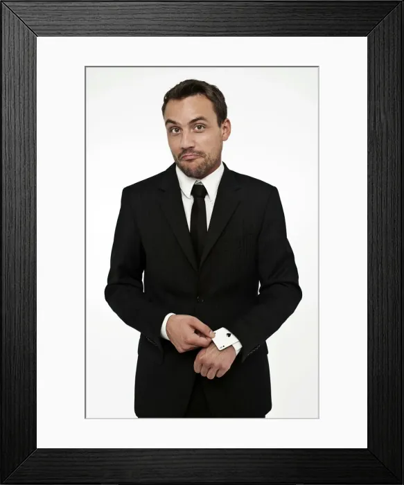 Framed Print : Man wearing a suit pulling an ace of spades out of his sleeve