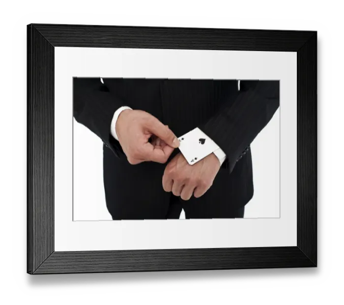 Framed Print : Man wearing a suit pulling an ace of spades out of his sleeve