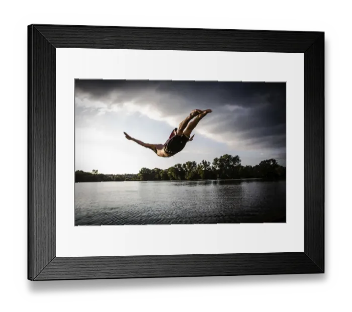 Framed Print : A young man plunging into water from the riverside, Germany Framed Print : A young man plunging into water from the riverside, Germany