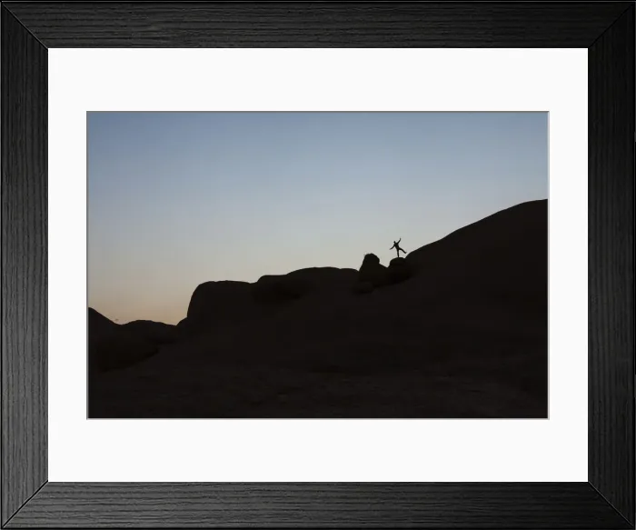 Framed Print : Young man jumping on a granite rock, near Spitzkoppe granite peaks, Damaraland, Namibia, Africa Framed Print : Young man jumping on a granite rock, near Spitzkoppe granite peaks, Damaraland, Namibia, Africa