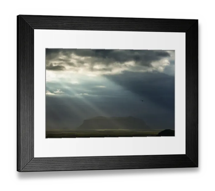 Framed Print : Sun rays shining through clouds, moody lighting, South Coast, Iceland, Europe Framed Print : Sun rays shining through clouds, moody lighting, South Coast, Iceland, Europe