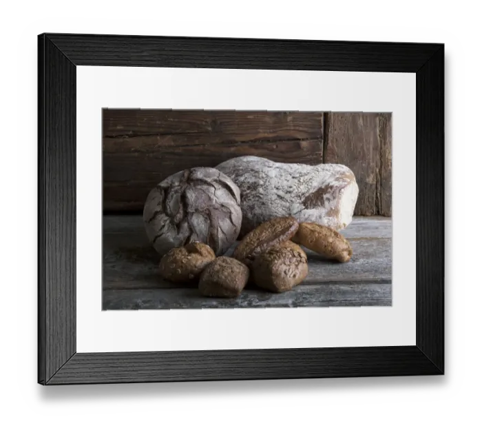 Framed Print : Bread loaves and rolls on a rustic wooden surface Framed Print : Bread loaves and rolls on a rustic wooden surface