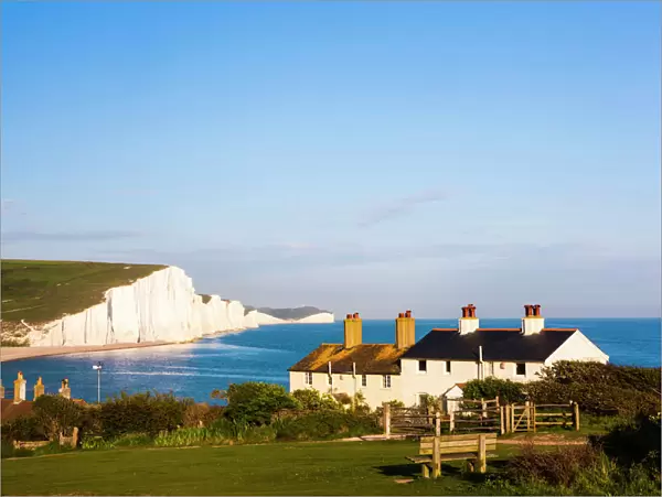 Houses in front of the Seven Sisters chalk cliffs, Seaford, Sussex, England, United Kingdom
